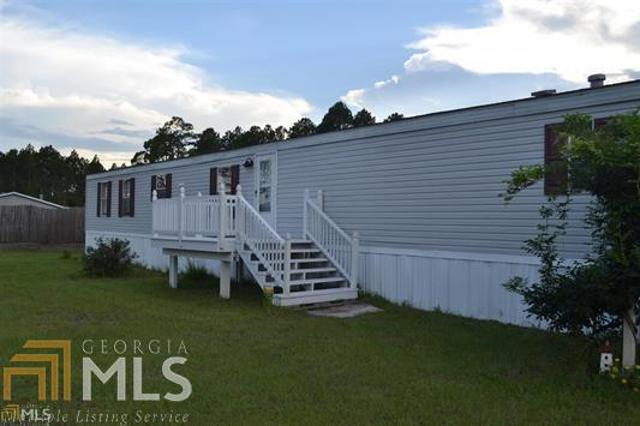 607 Whisper Ridge Loop Waynesville, GA 31566 - Photo 1 of 1 a view of a house with a yard