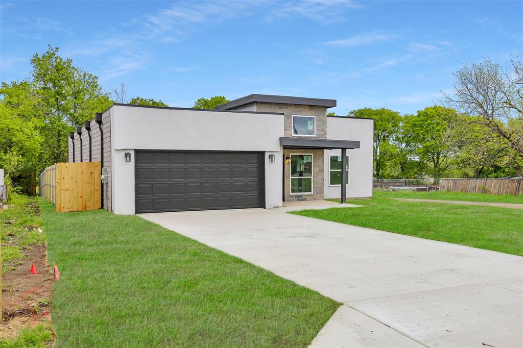 206 Gilmer Street Rice, TX 75155 - Photo 3 of 5 a front view of a house with a yard and garage