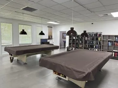 a living room with gym equipment and a table