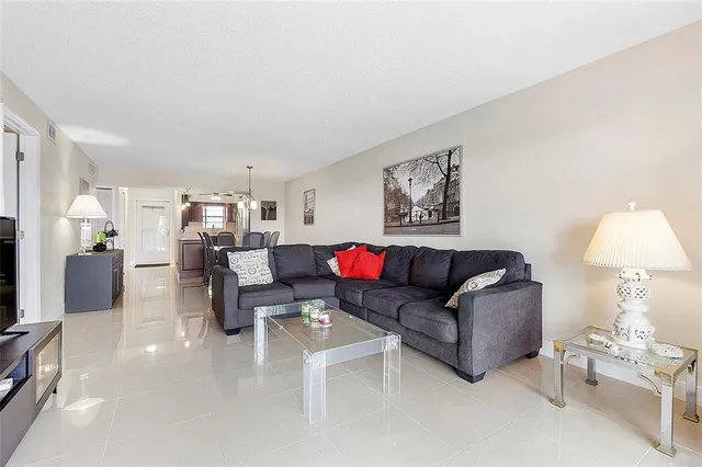 a living room with furniture and a lamp