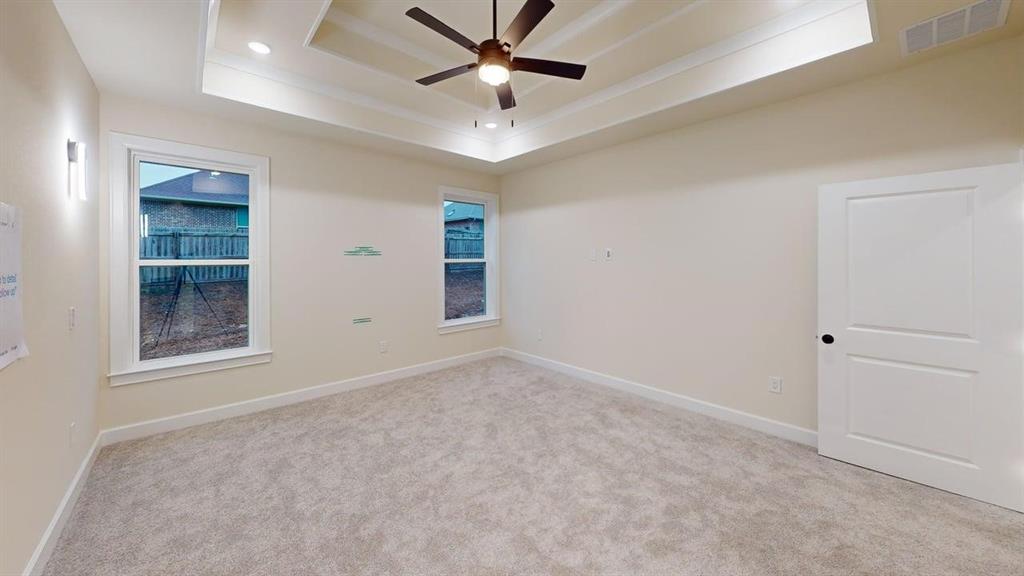2509 Windmill Lane Longview, TX 75601 - Photo 22 of 35 Carpeted spare room with a tray ceiling, ceiling fan, and recessed lighting