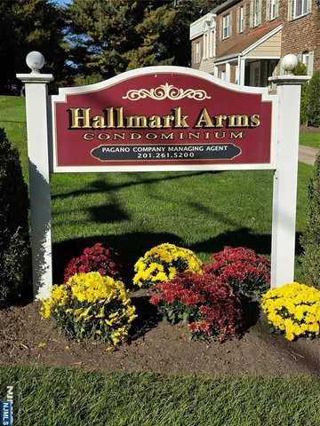 a sign that is sitting in front of flowers