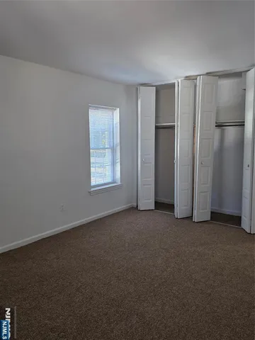 an empty room with a empty space and windows