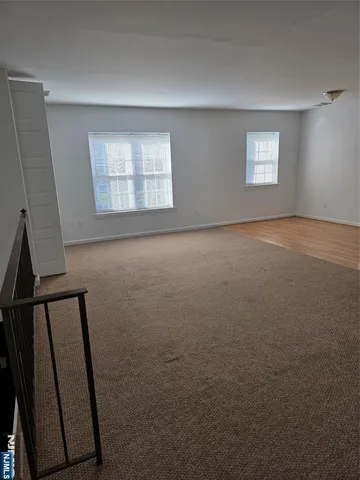 a view of empty room with windows