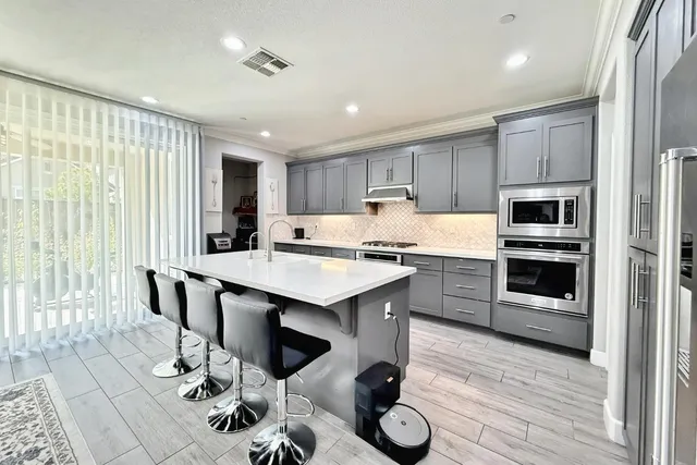 a large white kitchen with a large window