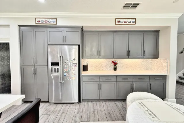 a view of a bedroom with window and hardwood floor