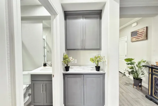 a view of a hallway with wooden floor and stairs