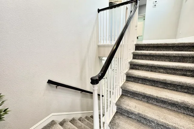 a bedroom with a large bed and a large window