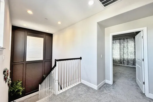 a spacious bedroom with a large bed and a large window