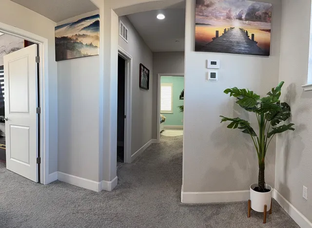 a bedroom with a bed and a potted plant