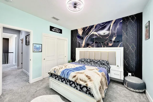 a bedroom with a bed and a desk