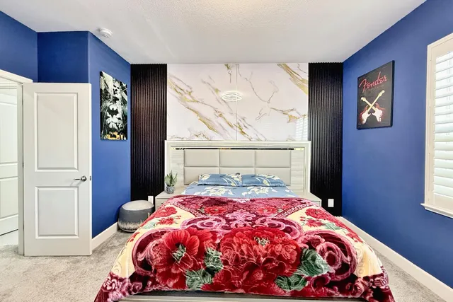 a view of a white house with large windows and a table