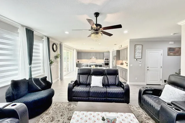 a living room with furniture dining table and a large window