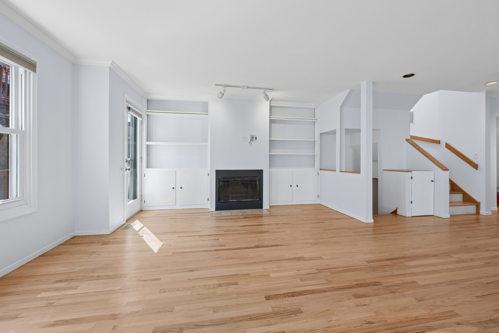3239 North Kenmore Avenue, Unit 5 Chicago, IL 60657 - Photo 11 of 35 a view of empty room with wooden floor and fireplace