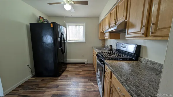 a kitchen with stainless steel appliances granite countertop a refrigerator and a stove