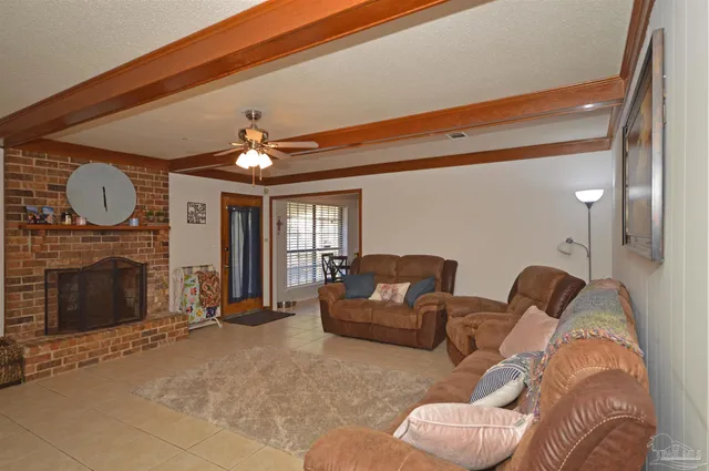 a living room with furniture a fireplace and a large window