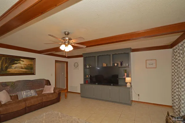 a living room with furniture a fireplace and a large window