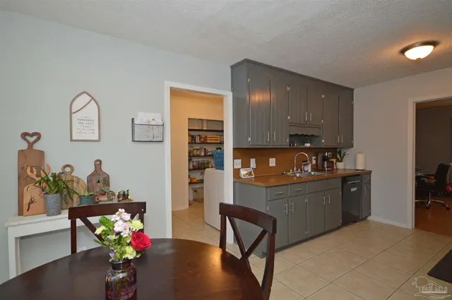 a kitchen with refrigerator and cabinets