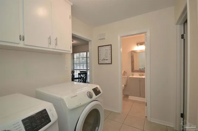 a bedroom with a bed chandelier and a window