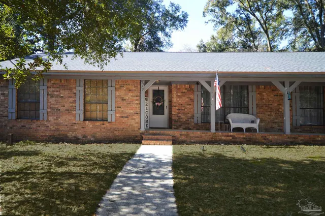 a view of a house with backyard and porch
