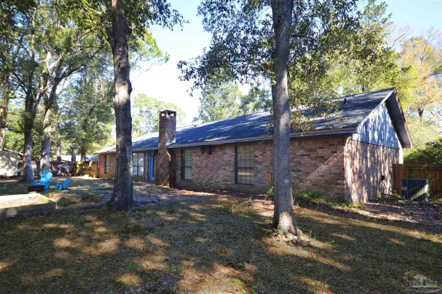 a view of a house with a tree in the background