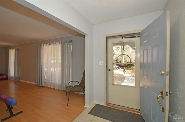 a view of a hallway with furniture and windows