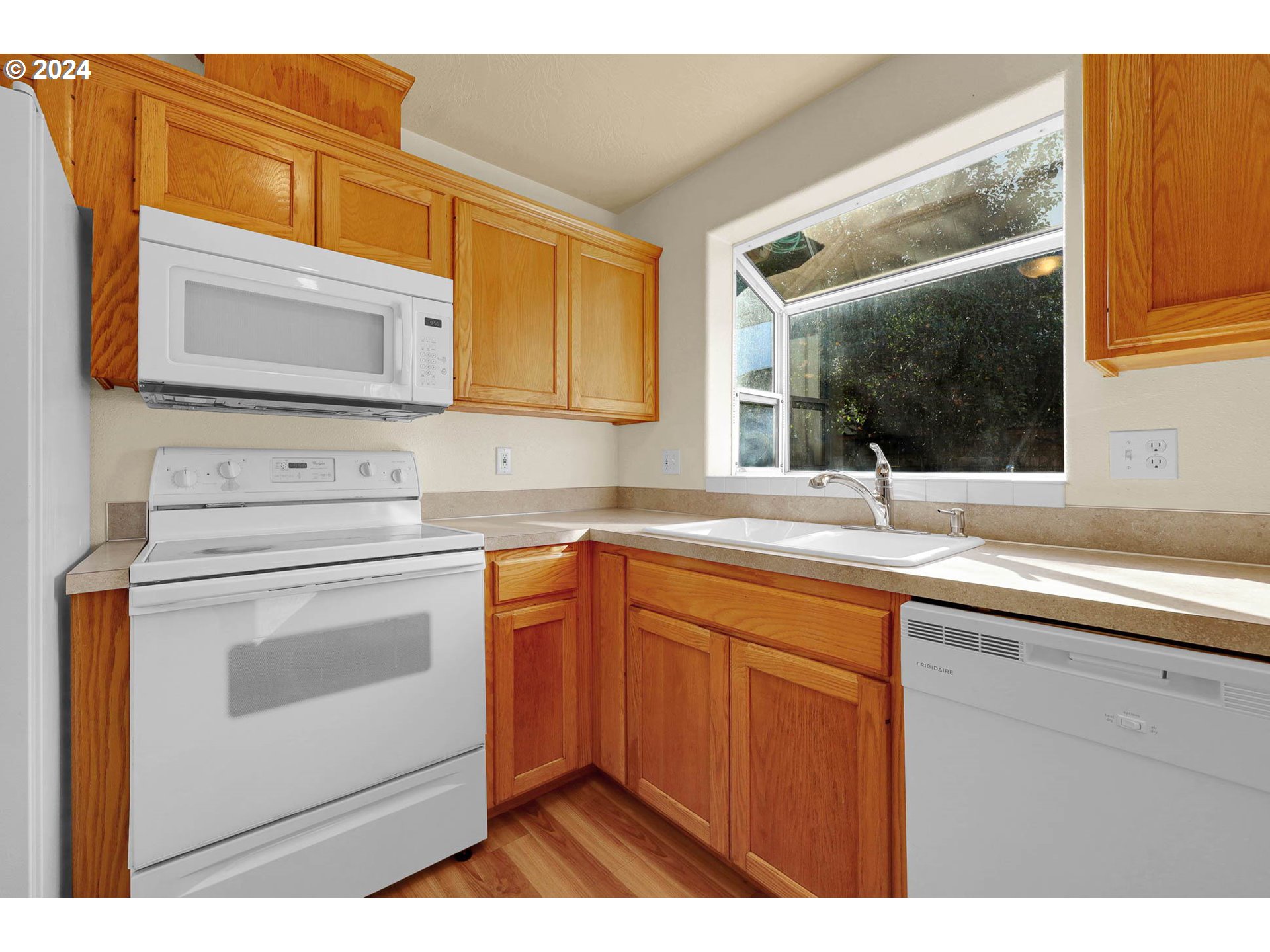 537 Nicholas Drive Springfield, OR 97477 - Photo 14 of 37 a kitchen with stainless steel appliances granite countertop a sink and cabinets with wooden floor
