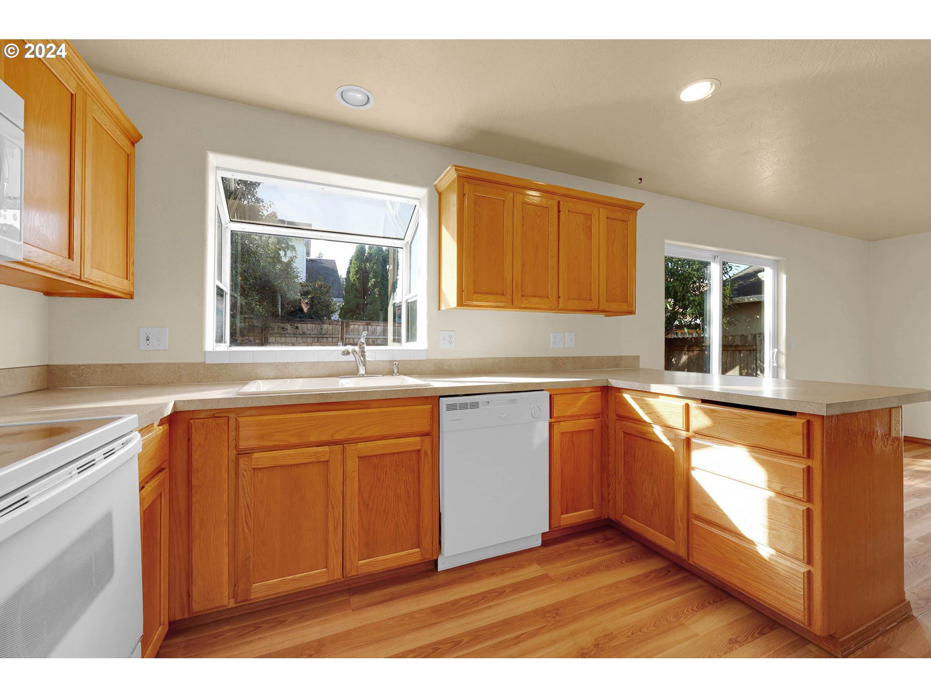 537 Nicholas Drive Springfield, OR 97477 - Photo 15 of 37 a kitchen with stainless steel appliances granite countertop a sink a stove and a refrigerator