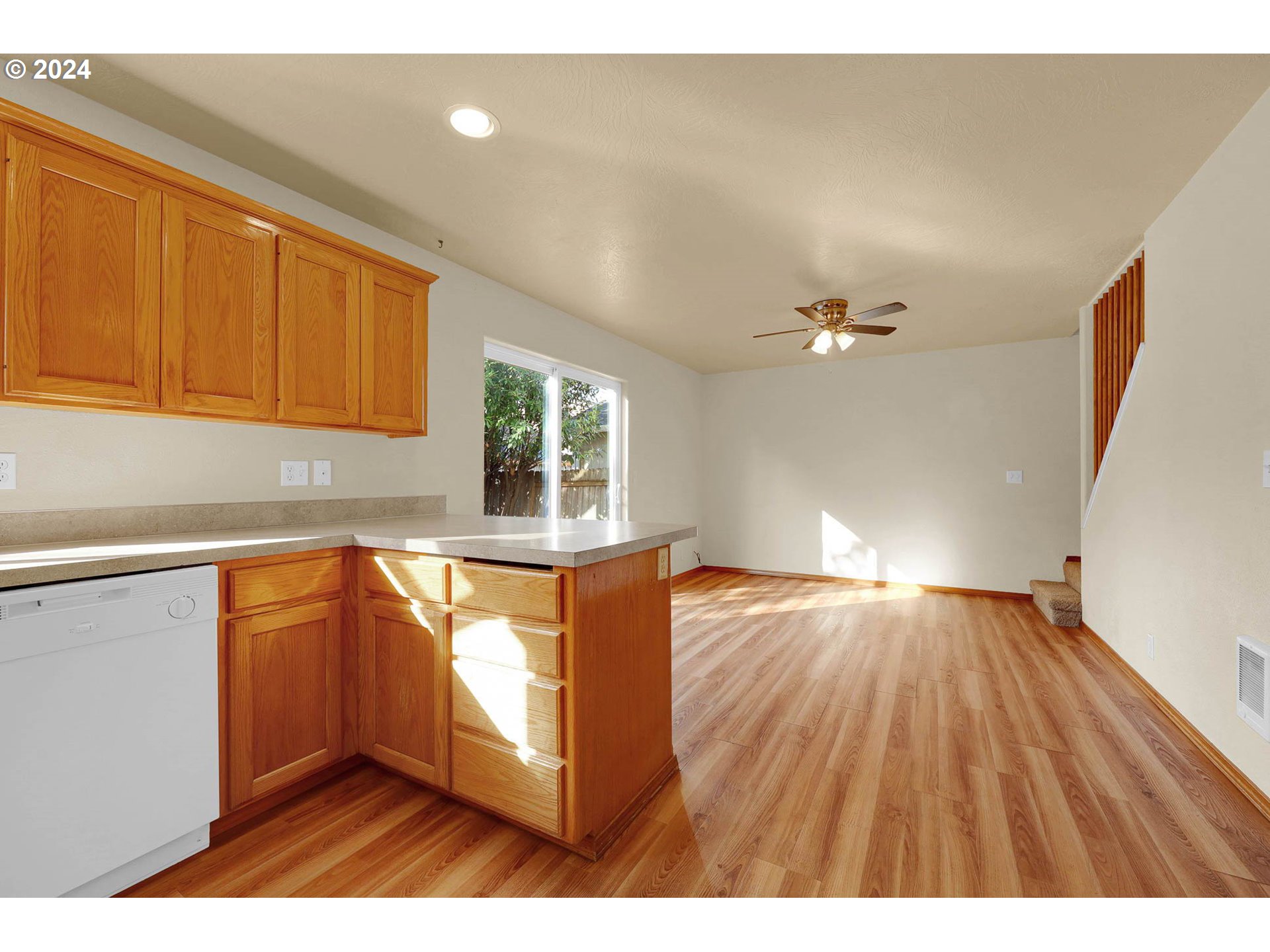 537 Nicholas Drive Springfield, OR 97477 - Photo 16 of 37 a kitchen with granite countertop wooden floors a sink and a microwave