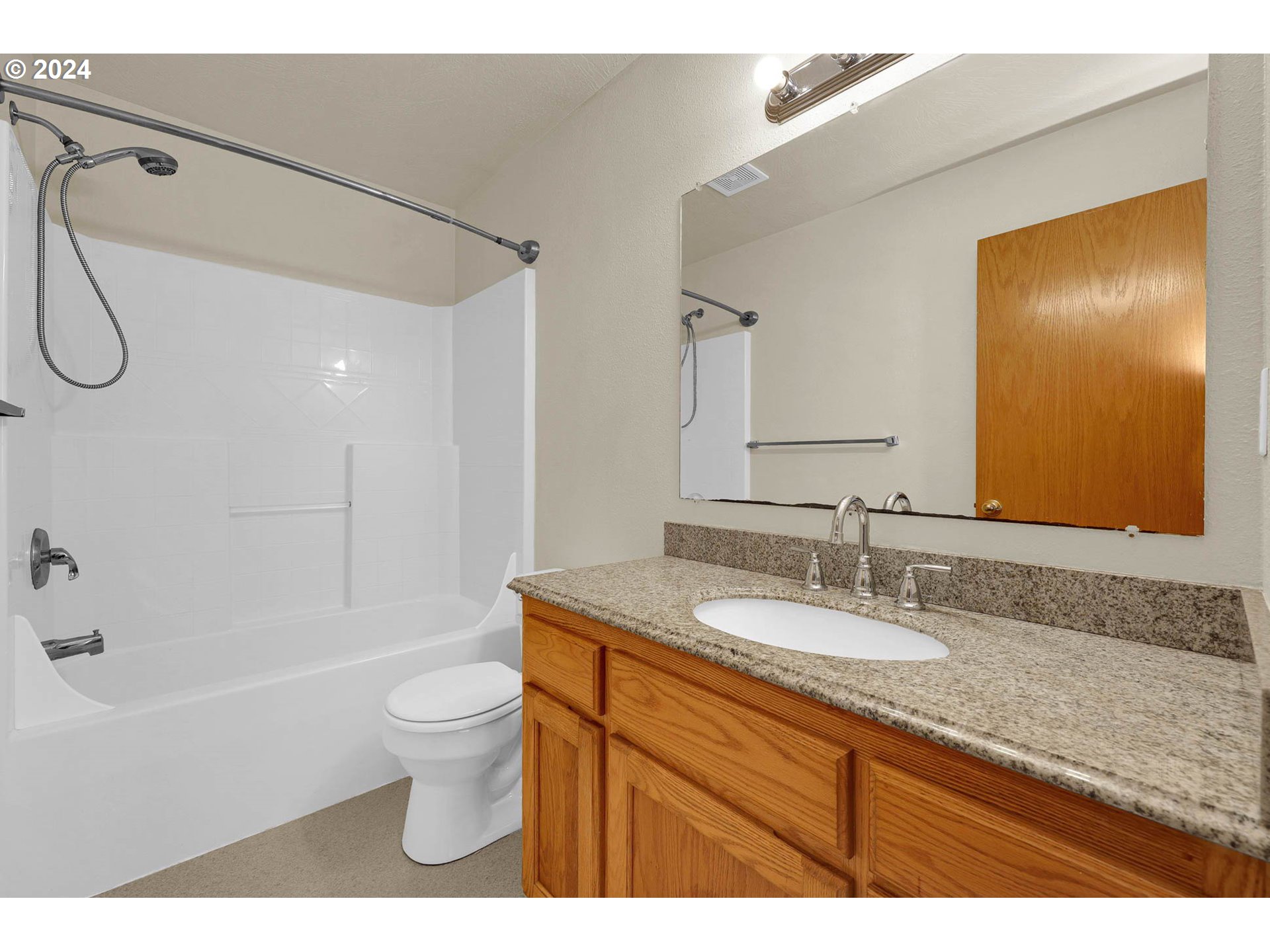 537 Nicholas Drive Springfield, OR 97477 - Photo 30 of 37 a bathroom with a granite countertop sink toilet a mirror and shower