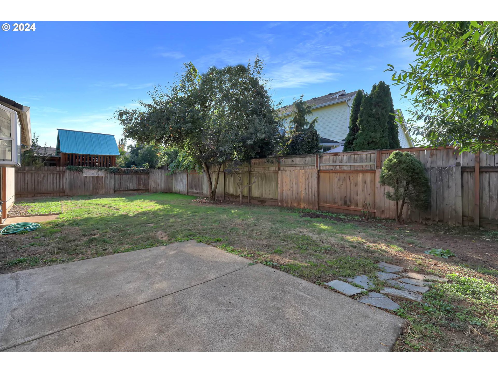 537 Nicholas Drive Springfield, OR 97477 - Photo 32 of 37 a view of a backyard with a garden and fire pit