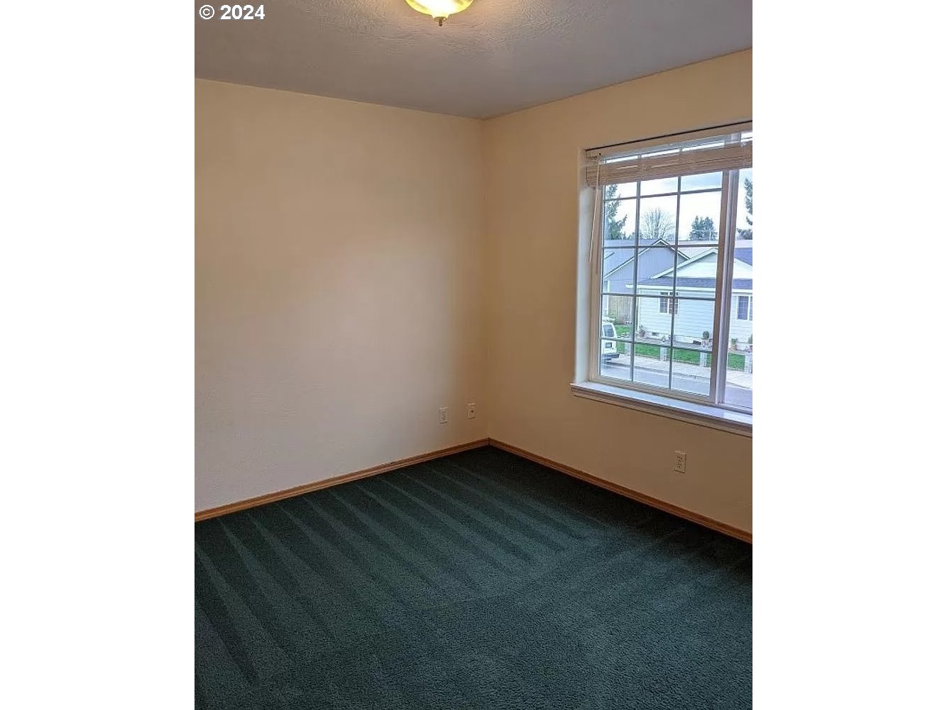 537 Nicholas Drive Springfield, OR 97477 - Photo 6 of 37 a view of an empty room with wooden floor and a window