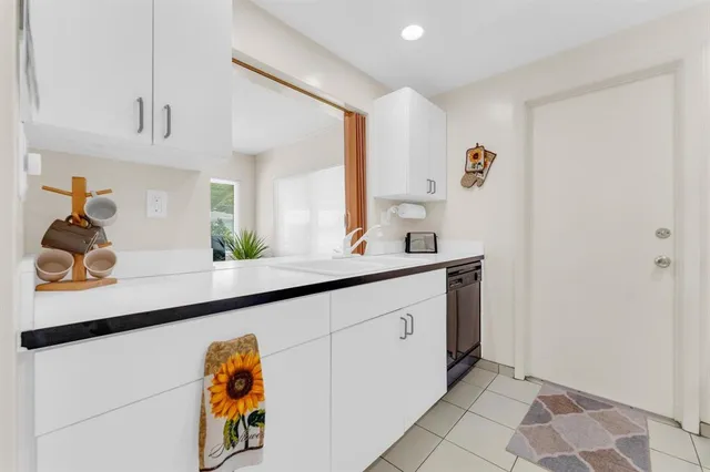 a kitchen with a sink cabinets and wooden floor