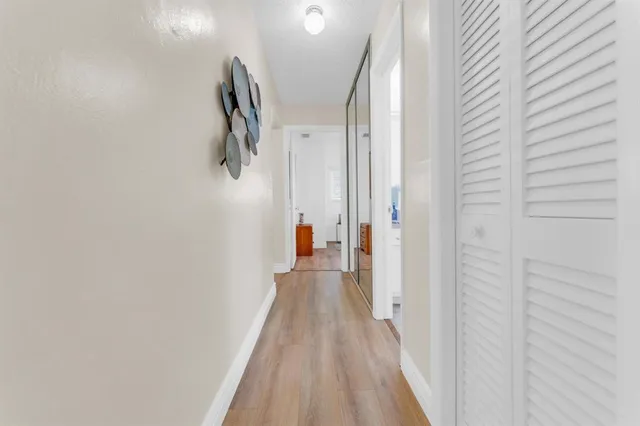 a bedroom with a bed a chandelier and a window