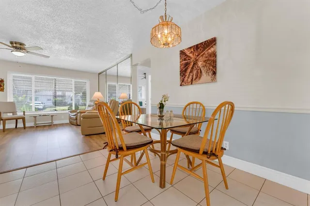 a patio with a table and chairs under an umbrella