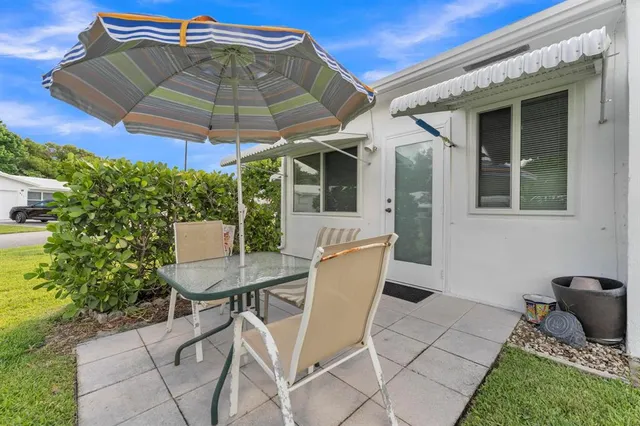 a view of balcony with two chairs and a potted plant