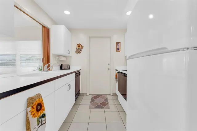 a bedroom with a bed and painting on the wall