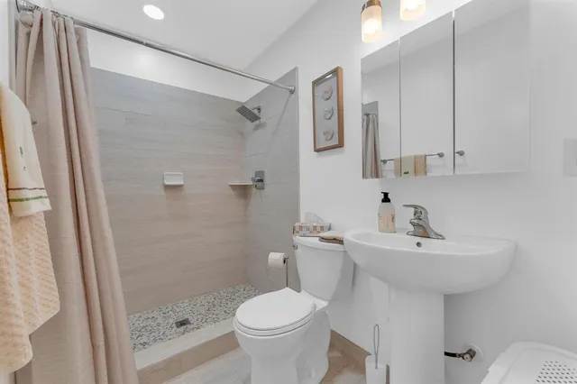 a bedroom with a bed and windows