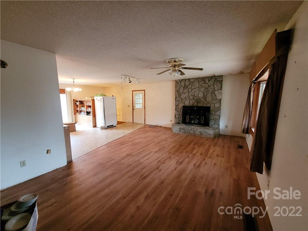 941 Engineer Road Bostic, NC 28018 - Photo 2 of 29 wooden floor in an empty room with a fireplace