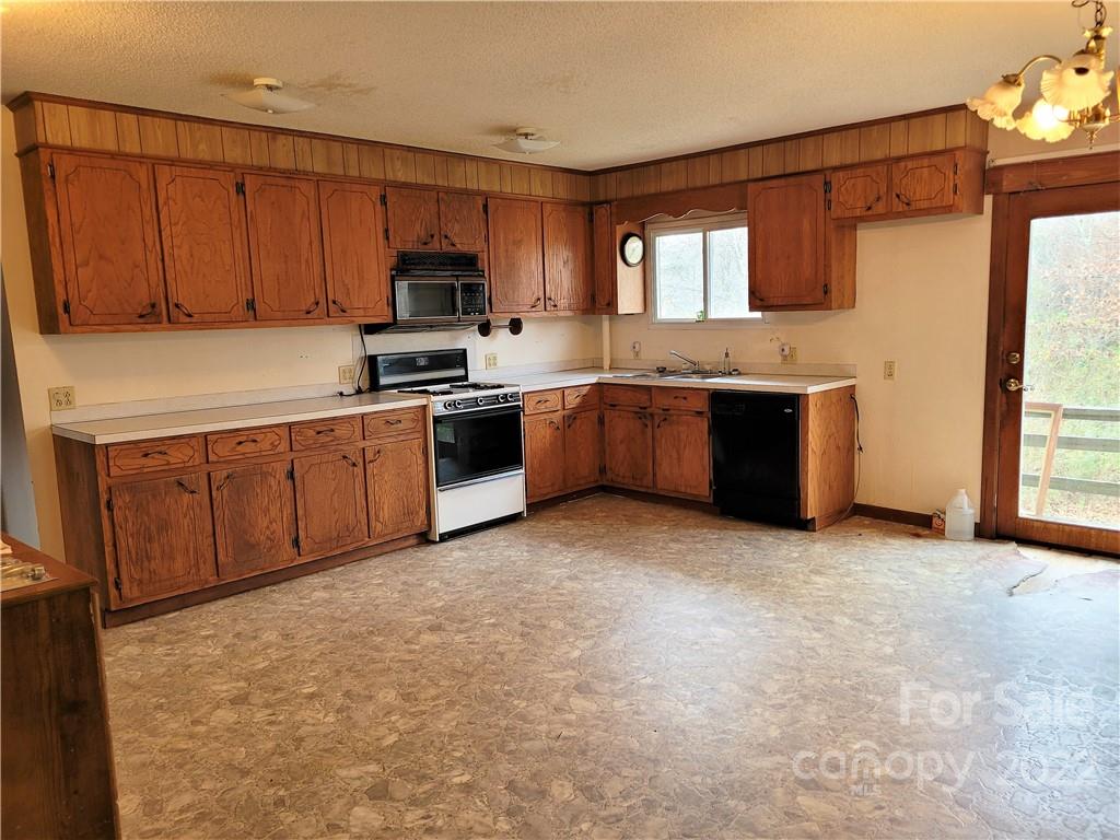 941 Engineer Road Bostic, NC 28018 - Photo 6 of 29 a kitchen with stainless steel appliances granite countertop a stove top oven a sink and dishwasher