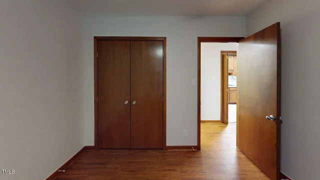 a bathroom with a granite countertop toilet a sink and a mirror