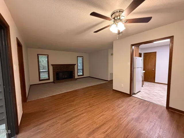 wooden floor fireplace and natural light in room