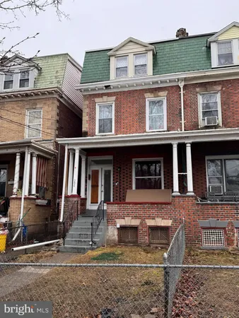 a front view of a house with parking space