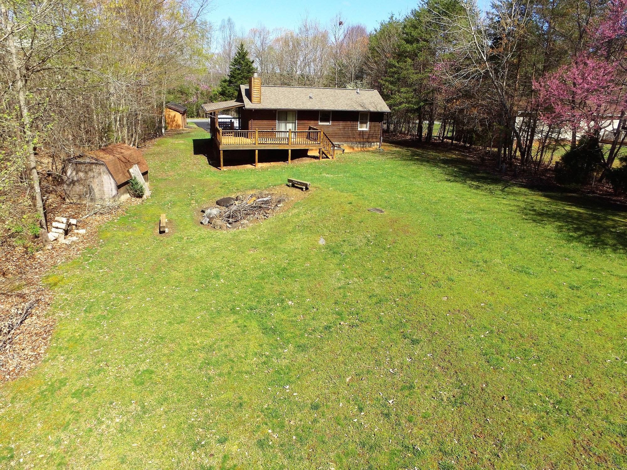 214 Highland Lake Road Union Hall, VA 24176 - Photo 21 of 33 a view of a house with a big yard potted plants and large tree