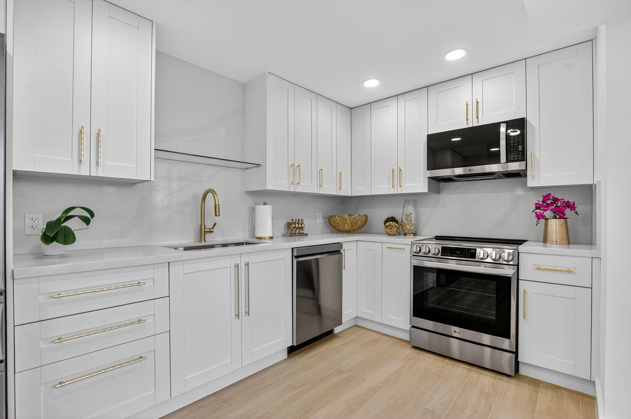 a kitchen with white cabinets and stainless steel appliances