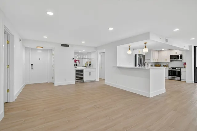 a kitchen with stainless steel appliances granite countertop a refrigerator microwave and stove top oven