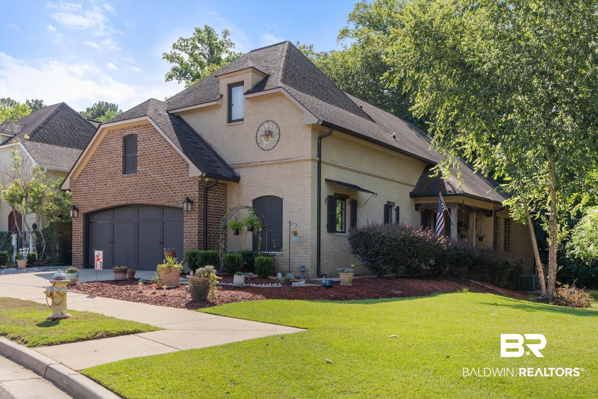 3400 Rue Royal Mobile, AL 36693 - Photo 1 of 33 French country style house with brick siding, roof with shingles, a front lawn, and driveway