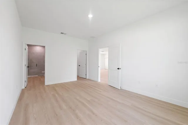 a bathroom with a double vanity sink toilet mirror and bathtub