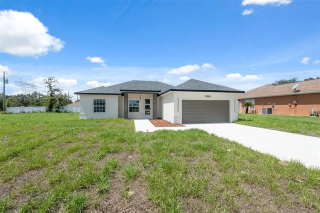 a front view of a house with yard and green space