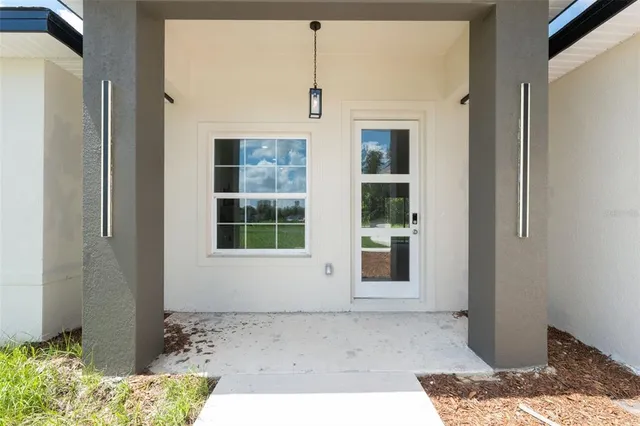 a large white kitchen with kitchen island a large counter space a sink appliances and cabinets